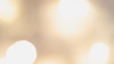 Golden bokeh background with soft, shimmering lights creating a warm, dreamy, and elegant ambianceの写真素材