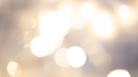 Golden bokeh background with soft, shimmering lights creating a warm, dreamy, and elegant ambianceの写真素材