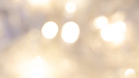 Golden bokeh background with soft, shimmering lights creating a warm, dreamy, and elegant ambianceの写真素材