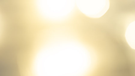 Golden bokeh background with soft, shimmering lights creating a warm, dreamy, and elegant ambianceの写真素材