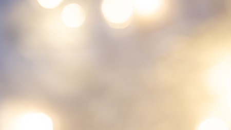 Golden bokeh background with soft, shimmering lights creating a warm, dreamy, and elegant ambianceの写真素材