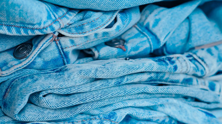 Blue jeans fabric with detailed texture, perfect for fashion and textile design visualsの写真素材