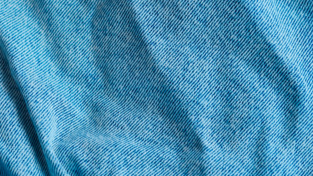 Blue jeans fabric with detailed texture, perfect for fashion and textile design visualsの写真素材
