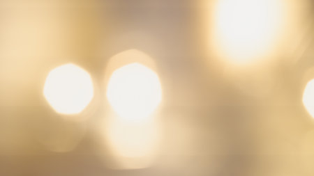 Golden bokeh background with soft, shimmering lights creating a warm, dreamy, and elegant ambianceの写真素材