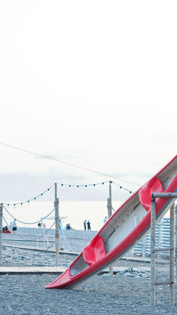 red kayak on the shore at the seaside in the summer evening.の写真素材