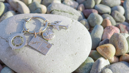 keychain with the travel signs airplane ,globes ,earth on the nature background.