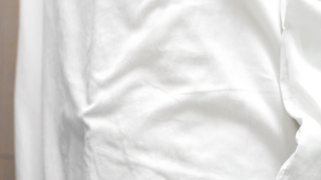 Smooth white bedsheet background, soft texture, clean and minimalist styleの写真素材