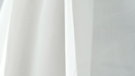 Smooth white fabric background with ample copy space for text or design elementsの写真素材