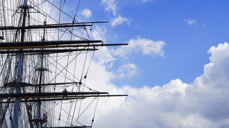 Braces, shkots, halyards on a sailing ship, sky backdrop, maritime ropes theme.