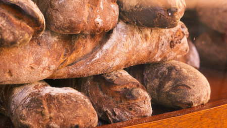 Artisan fresh bread on a street showcase, golden brown crust and rustic appearance.
