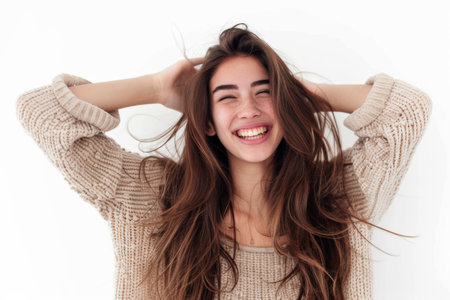 Dark brown haired woman on a white background, glowing skin and smooth hairstyleの素材