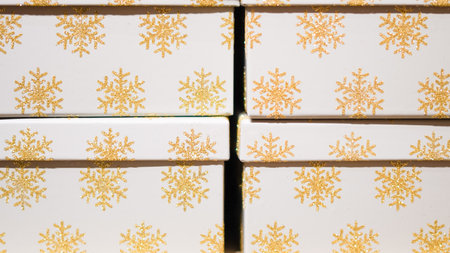 Christmas gift boxes with festive wrapping, ribbons, and decorationsの写真素材