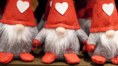 red Santa displayed on a festive holiday showcase with warm lighting..の写真素材