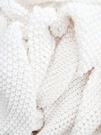A detailed view of a white knitted plaid background, showing delicate woven textures. High quality photoの写真素材