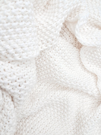 A detailed view of a white knitted plaid background, showing delicate woven textures. High quality photoの写真素材