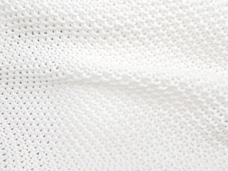 A cozy white knitted plaid background with soft, minimalist details and woven charm. High quality photoの写真素材