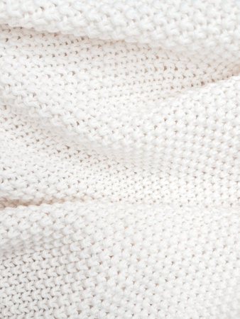 A detailed view of a white knitted plaid background, showing delicate woven textures. High quality photoの写真素材