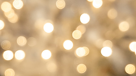 Soft blurred golden and brown bokeh with warm Christmas light reflections. High quality photoの写真素材