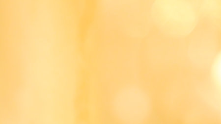 Glowing golden bokeh lights creating a warm, festive, and dreamy backgroundの写真素材