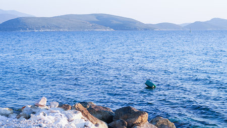 Clear blue calm sea under sunny sky, reflecting natural beauty and tranquilityの写真素材