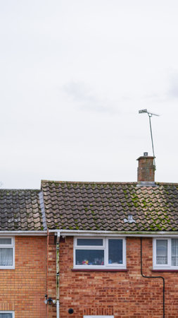 A misty morning over British suburban rooftops with brick housesの写真素材