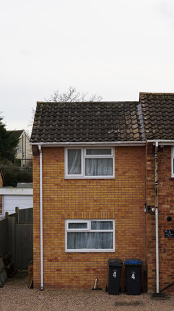 A misty morning over British suburban rooftops with brick housesの写真素材