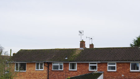 Traditional English rooftops in a suburban neighborhood under cloudy skies.の写真素材