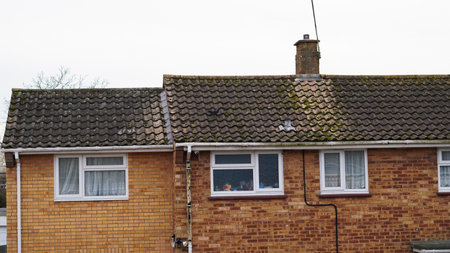 A misty morning over British suburban rooftops with brick housesの写真素材