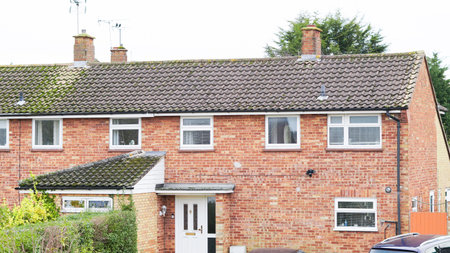 A view of English residential rooftops in an overcast suburban districtの写真素材