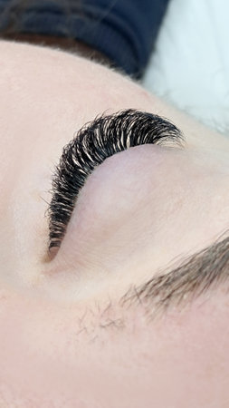 Close up of eye with eyelash extensions ,beauty salon treatment ,2d volume, 3d volume, classical lashes,Russian volume,megavolume, new setの写真素材