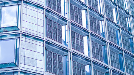 Business skyscraper with blue glass facade reflecting urban cityscapeの写真素材