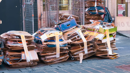 Large stacks of used cardboard outside, organized for waste recyclingの写真素材