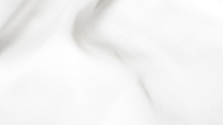 Smooth white silk fabric with soft folds and gentle light reflectionsの写真素材