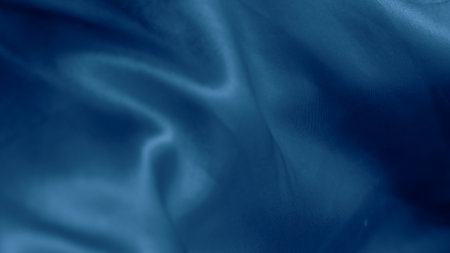 Soft blue silk folds create a hypnotic effect with smooth flowing patternsの写真素材