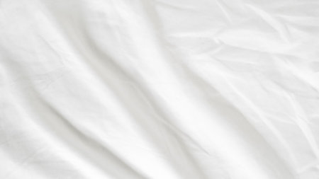 White bedding with soft folds and empty space for design or text placementの写真素材