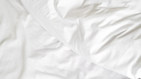 White bedding with soft folds and empty space for design or text placementの写真素材