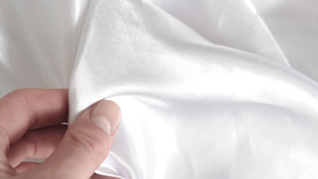 White silk with subtle folds, creating a soft and clean backgroundの写真素材
