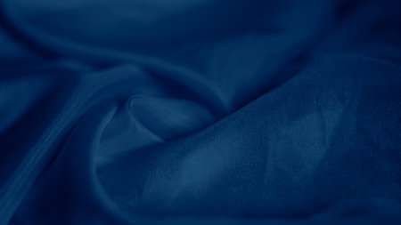 Elegant blue silk fabric draped gracefully with a soft iridescent shineの写真素材