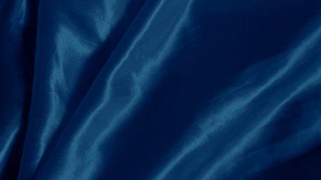 Soft blue silk folds create a hypnotic effect with smooth flowing patternsの写真素材