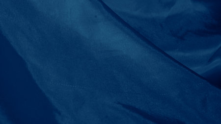 Elegant blue silk fabric draped gracefully with a soft iridescent shineの写真素材