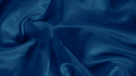 Abstract blue silk waves reflecting light with a gentle luminous glowの写真素材
