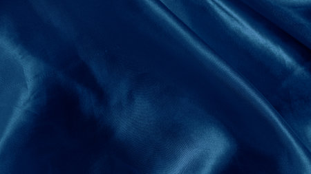 Dreamy silk texture in soft blue shades with flowing waves and delicate glowの写真素材