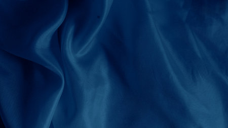 Elegant blue silk fabric draped gracefully with a soft iridescent shineの写真素材