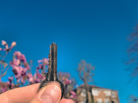 A successful real estate deal symbolized by a key in handの写真素材