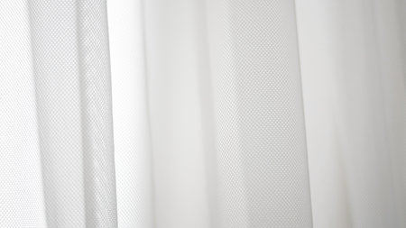Sheer white tulle texture ideal for modern backgrounds or styling layers.の写真素材
