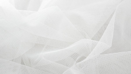 Light white tulle fabric texture background for soft elegant visual design.の写真素材