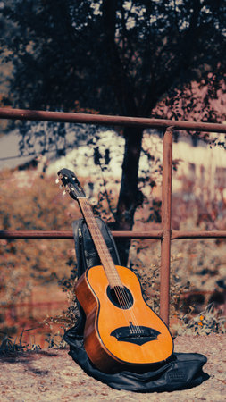 Guitar left on the road with street musician vibe in urban areaの写真素材