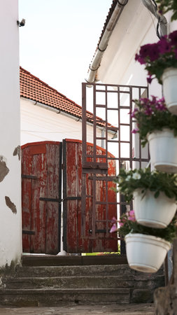 A close-up of an old wooden gate at the entrance to a rustic houseの写真素材