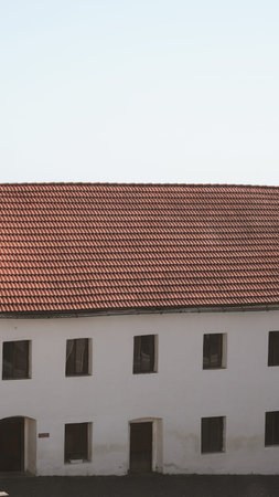 Old building with tile roofs and historical architecture in scenic settingの写真素材