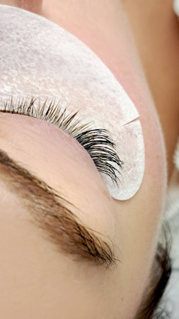 close up of eye with eyelash extensions in beauty salon macro eye top view.の写真素材